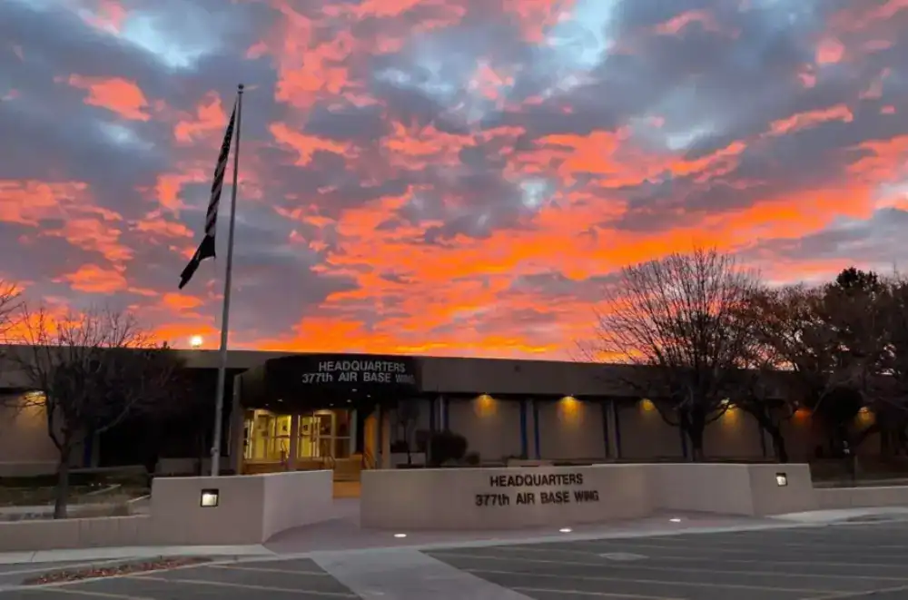 Sunset sky above a police department building and flagpole.