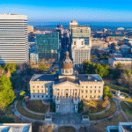 Aerial view of historic government buildings with modern city skyline in the background.