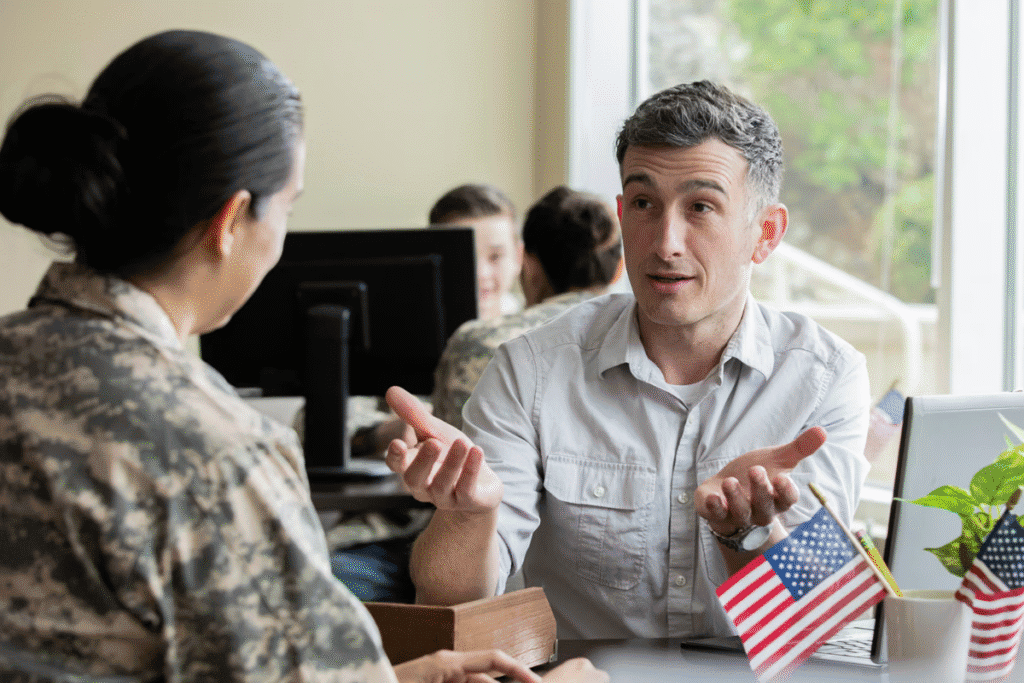 Veteran discussing career opportunities with a recruiter at PCS Pay-it-Forward.